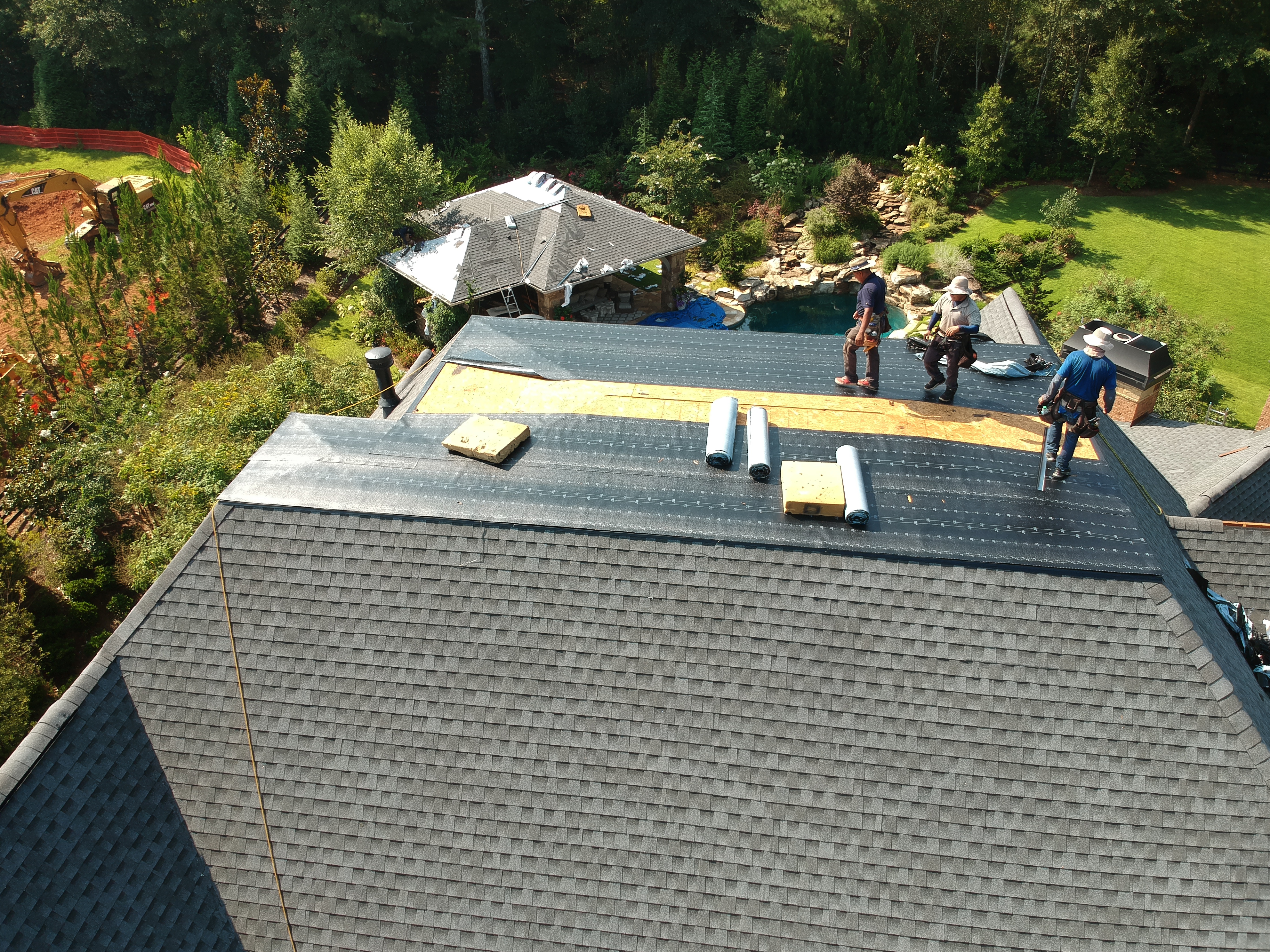 Multi-level residential home in metro Atlanta with flat and steep roof sections requiring coordinated roofing systems